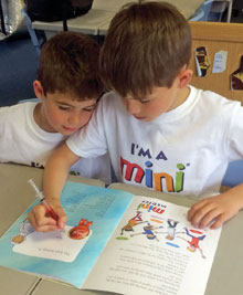 Photo of Mini Medics first aid course participants writing in the 32-page workbook